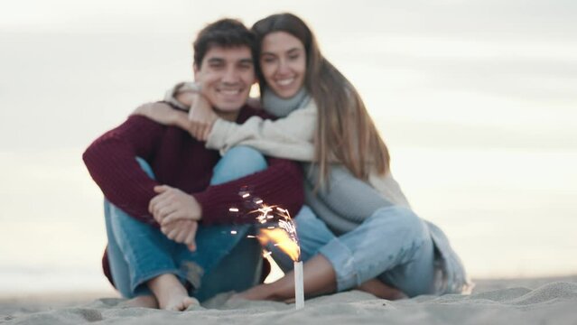 Video of beautiful young couple in love enjoying the day in a cold winter on the beach.