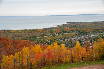 Blue mountain ski hill runs with the town of Collingwood and Georgian Bay in the background during autumn