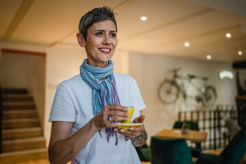 Portrait of woman senior caucasian female stand in cafe happy smile