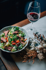 warm salad with herbs and vegetables with red wine