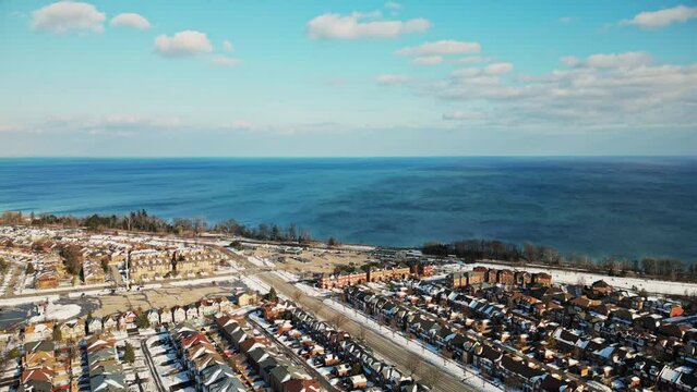 pickering ontario water train tracks winter time blue skies and clouds drone view