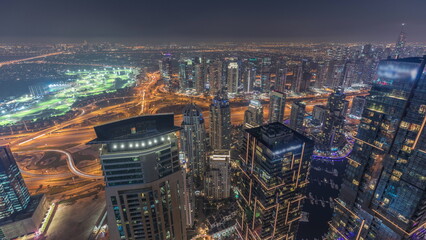 Panorama of Dubai Marina with JLT skyscrapers and golf course day to night timelapse, Dubai, United Arab Emirates.