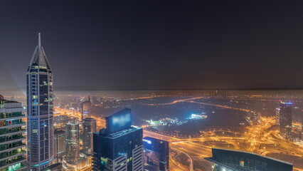 Aerial skyline with Golf Club, hotels and residential areas far away in desert in Dubai all night timelapse, UAE, top view