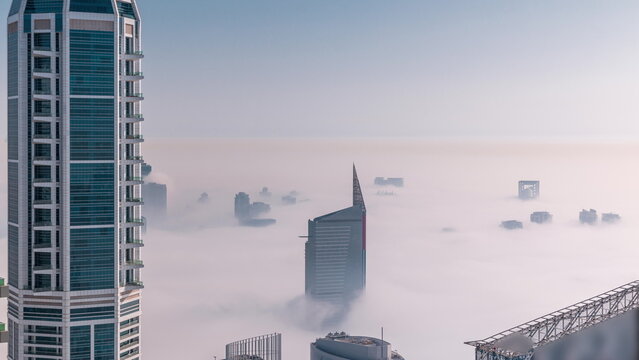Dubai Aerial view showing fog over al barsha heights and greens district area timelapse