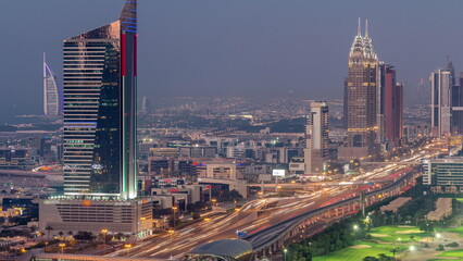 Aerial view of Sheikh Zayed Road in Dubai Internet City area day to night timelapse - obrazy, fototapety, plakaty