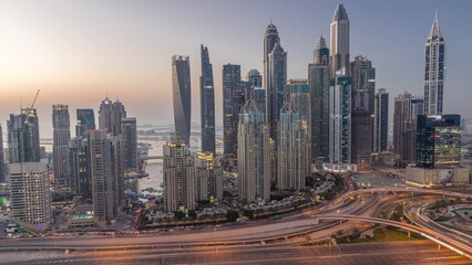 Skyscrapers of Dubai Marina near intersection on Sheikh Zayed Road with highest residential buildings day to night timelapse