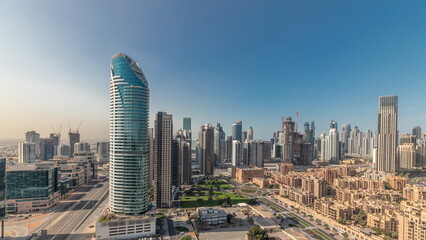 Naklejka na ściany i meble Panorama showing Dubai's business bay towers aerial morning timelapse. Rooftop view of some skyscrapers