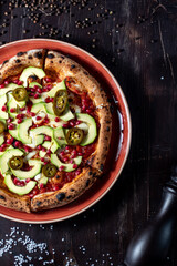 Pizza with avacado, jalapeno and pomegranate seeds
