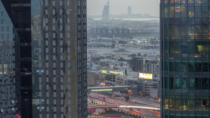 Fototapeta na wymiar Villas and famous hotel in the horizon line from Dubai downtown with big intersection aerial day to night timelapse
