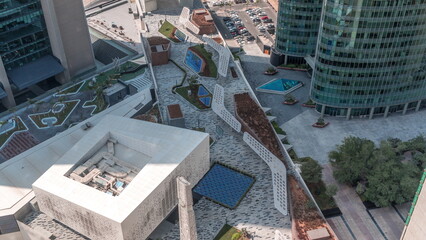 Dubai international financial center skyscrapers with promenade on a gate avenue aerial all day timelapse.