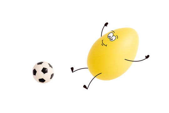 Funny Easter Egg With Cute Face Playing Football Isolated On White Background. Cute Yellow Egg Character Jumping To Hit Soccer Ball. Sports, Training And Healthy Lifestyle. Protein And Nutrition