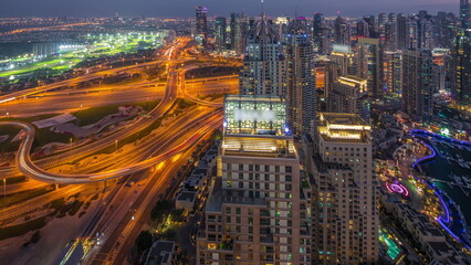Dubai marina and JLT skyscrapers along Sheikh Zayed Road aerial day to night timelapse.