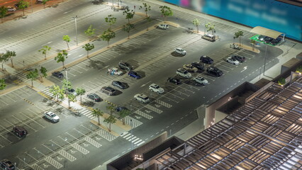 Top view busy parking lot with many cars moving in and out night timelapse. © HyperlapsePro