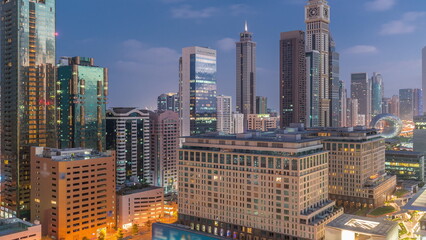 Fototapeta na wymiar Dubai International Financial district aerial night to day timelapse. View of business office towers.