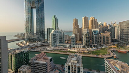 Fototapeta na wymiar Panorama showing Dubai Marina skyscrapers and JBR district with luxury buildings and resorts aerial timelapse