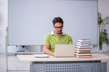 Young male student preparing for exams in the classroom