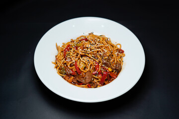 Noodles with meat isolated black background