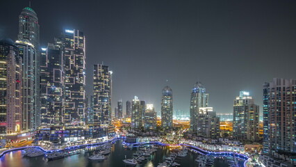 Naklejka premium Luxury yacht bay in the city aerial night timelapse in Dubai marina