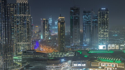 Dubai downtown near fountains and modern futuristic architecture aerial night timelapse