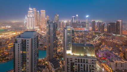 Naklejka premium Aerial view of a big futuristic city day to night timelapse. Business bay and Downtown