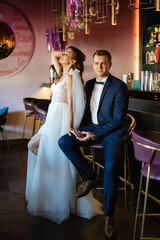 bride and groom inside a cocktail bar