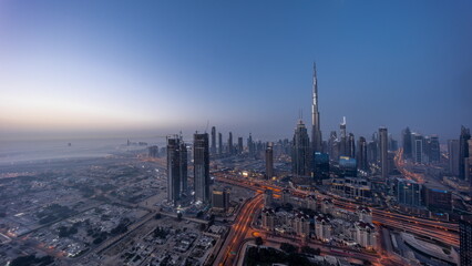 Fototapeta na wymiar Aerial view of tallest towers in Dubai Downtown skyline and highway night to day timelapse.