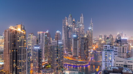 Fototapeta na wymiar View of various skyscrapers in tallest recidential block in Dubai Marina aerial day to night timelapse