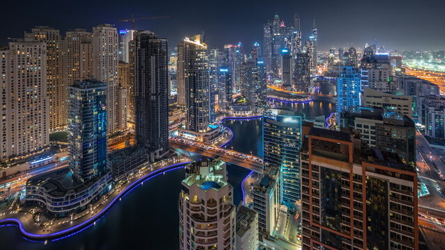 Panorama showing various skyscrapers in tallest recidential block in Dubai Marina aerial night timelapse
