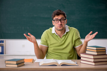 Young male student sitting in the classroom