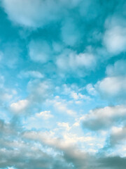 Blue sky scattered with light white and grey clouds