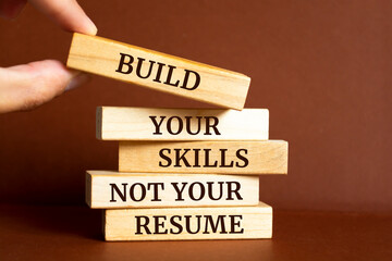 Wooden blocks with words 'Build your skills not your resume'.