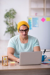 Young male designer sitting in the office