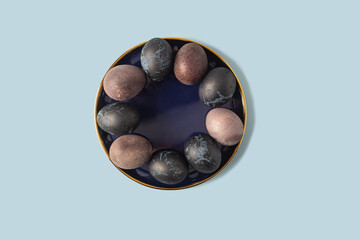 Blue and purple easter eggs on a blue background