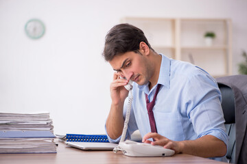 Fototapeta premium Young male employee working in the office