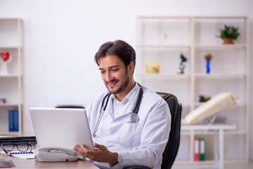 Young male doctor in telemedicine concept