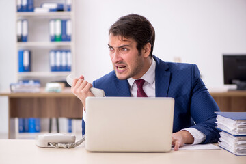 Young male employee working in the office