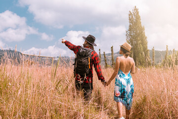 A Couple Hiking Through a Beautiful Meadow on a Warm Summer Afternoon