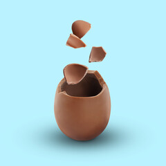 Exploded milk chocolate egg on light blue background