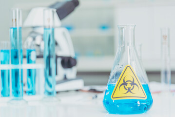 Biohazard disease alert corona outbreak sign on glass wall laboratory science center. Medical care clinic with hazard alert sign. Medical Healthcare concept.