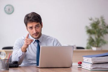 Young male employee working in the office