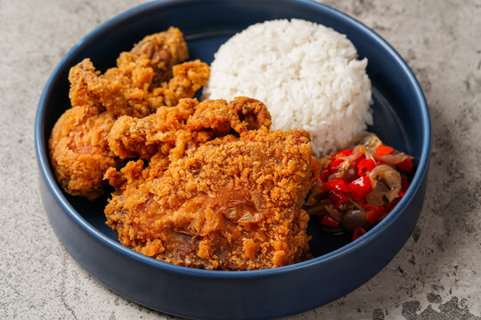 Ayam Geprek is an Indonesian Food crispy fried chicken with hot and spicy sambal Chili Sauce.