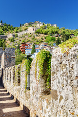 Fortress walls of Alanya Castle and modern houses in Turkey