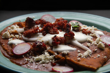 Mexican enfrijoladas with chorizo and fresh cheese