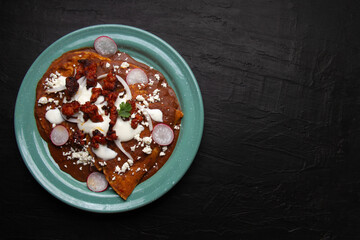 Mexican enfrijoladas with chorizo and fresh cheese