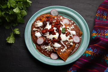 Mexican enfrijoladas with chorizo and fresh cheese