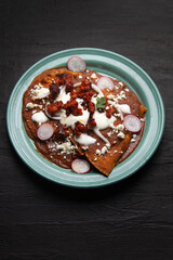 Mexican enfrijoladas with chorizo and fresh cheese