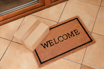 Parcel on mat near front door indoors, above view