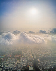 Aerial view of Saigon cityscape at morning with misty sky in Southern Vietnam. Urban development texture, transport infrastructure and green parks