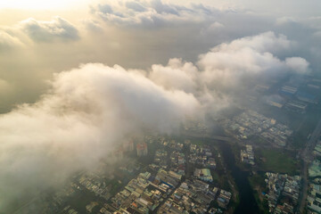 Aerial view of Saigon cityscape at morning with misty sky in Southern Vietnam. Urban development texture, transport infrastructure and green parks