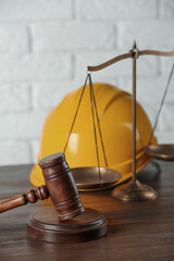 Labour, construction and land law concepts. Judge gavel, scales of justice with protective helmet...